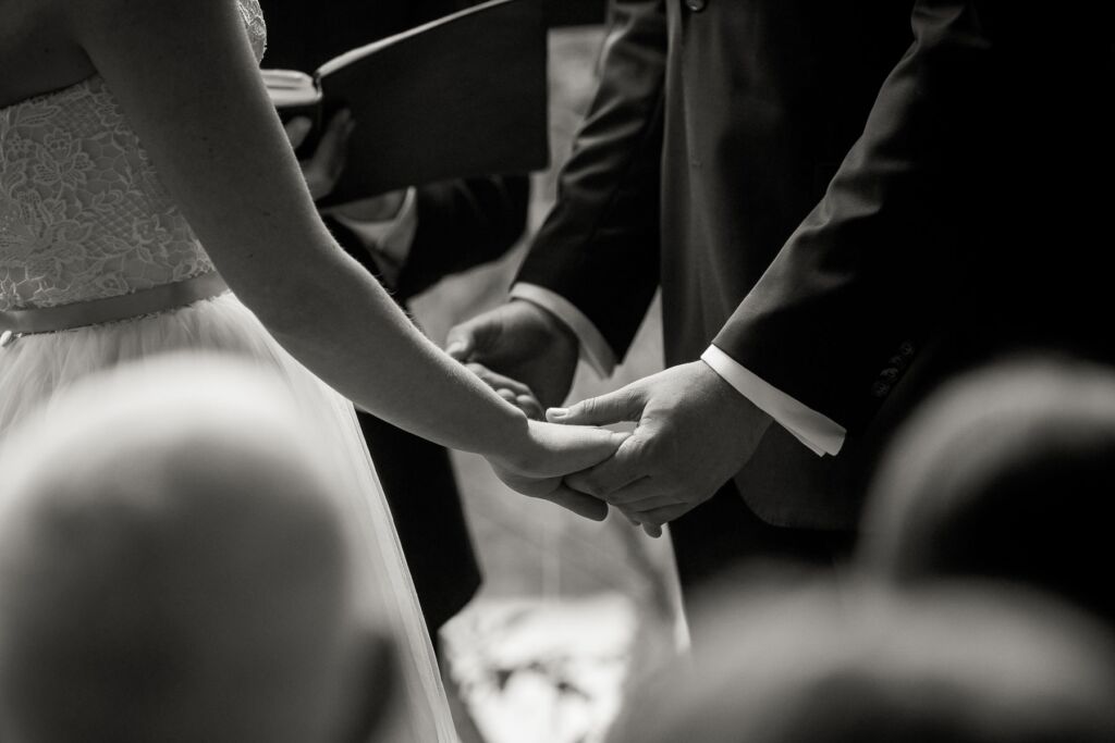 Bride and groom hold hands at wedding ceremony New Orleans