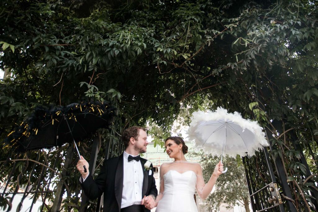 bride and groom with secondline umbrellas