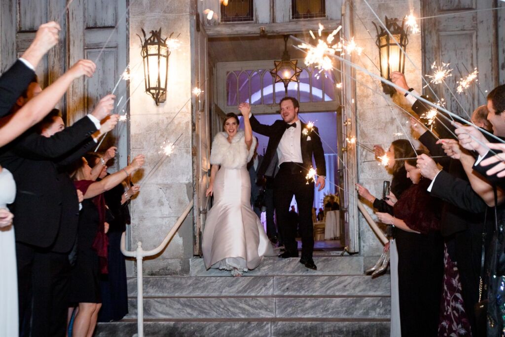Bride and groom exit their wedding with sparklers