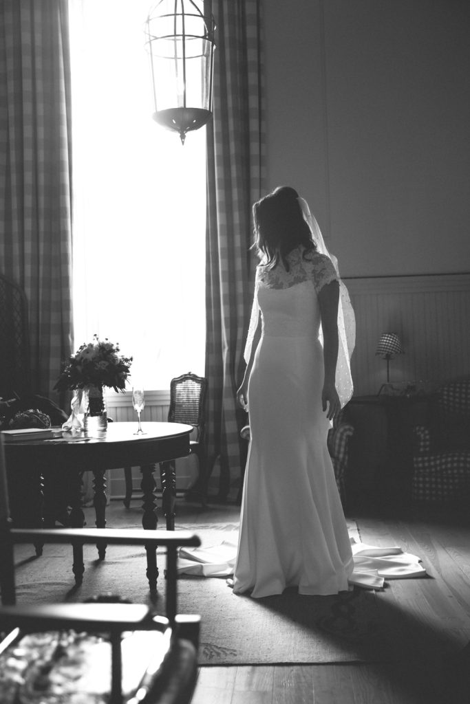 Bride looks back at her train in a room at the Hotel Peter & Paul